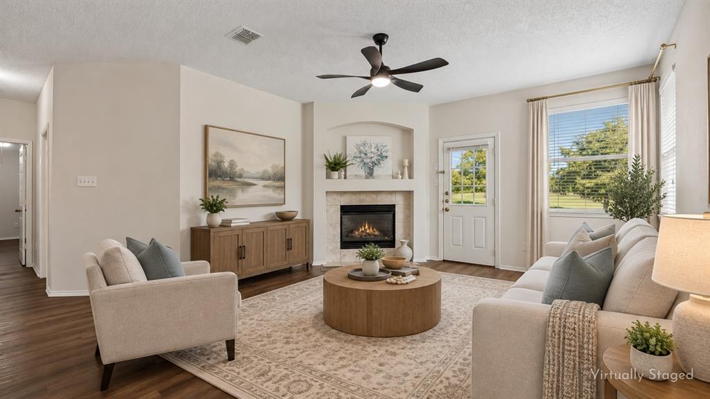 A Family Room Made for Everyday Living – Spacious and comfortable, the family room features LVP flooring, a gas fireplace, an updated ceiling fan, and windows that bring in natural light and views toward the golf course.