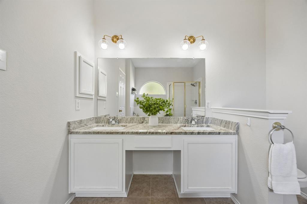 A Primary Bath with Room to Share – A wide dual-sink vanity with a granite top, updated fixtures, and generous counter space creates a functional setup for busy mornings and everyday routines.