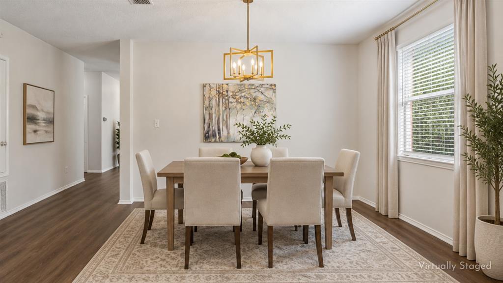 A Dining Room Ready for More Than Dinner – The dedicated formal dining area offers generous wall space, a large window for natural light, and updated lighting overhead, making it equally suited for dinner parties, celebrations, or game nights.