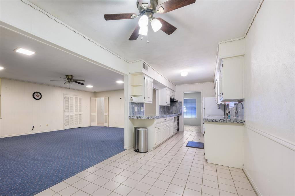 Kitchen with white cabinetry, light-colored countertops, and tile flooring