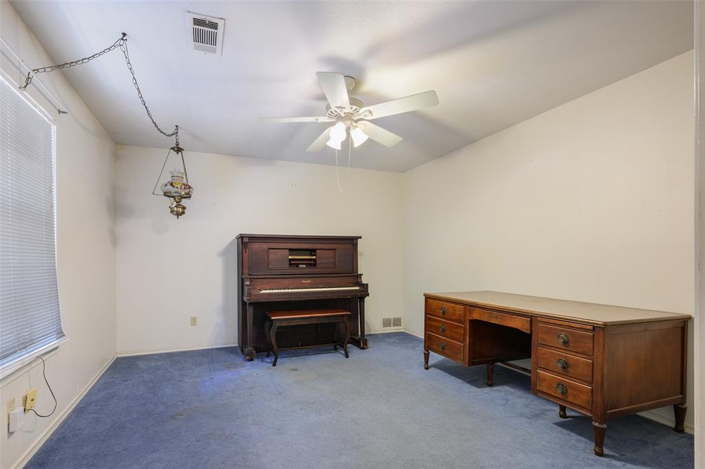 Angled ceiling, ceiling fan, wall-to-wall carpeting, window with blinds