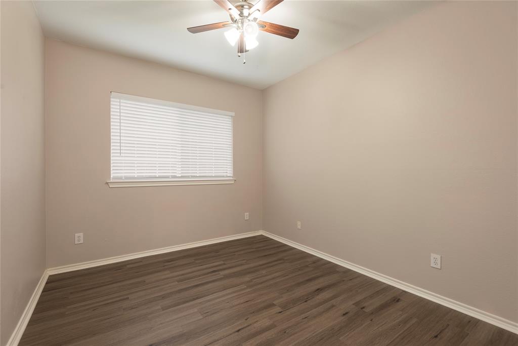 Spare room with ceiling fan and dark hardwood / wood-style flooring