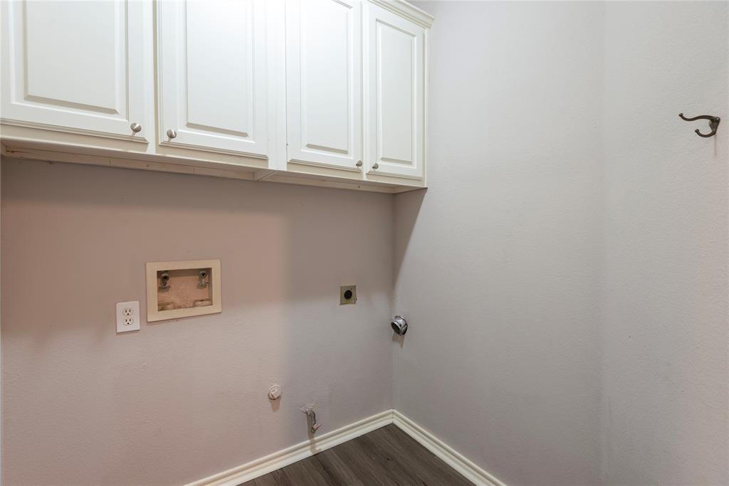 Clothes washing area with electric dryer hookup, cabinets, gas dryer hookup, dark wood-type flooring, and hookup for a washing machine