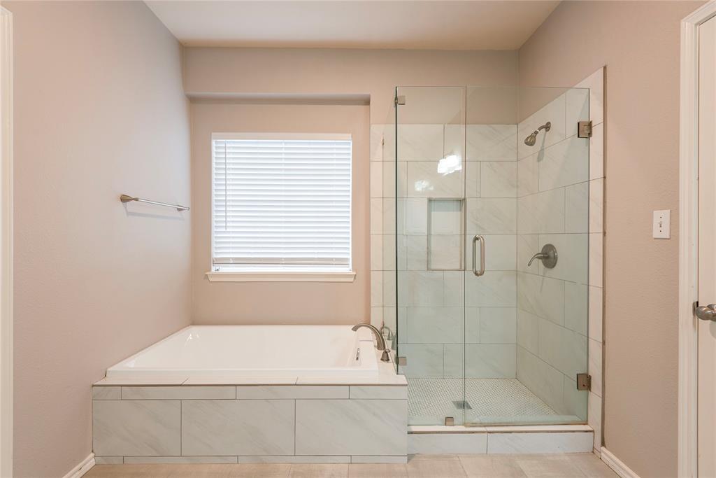Bathroom featuring tile patterned floors and shower with separate bathtub