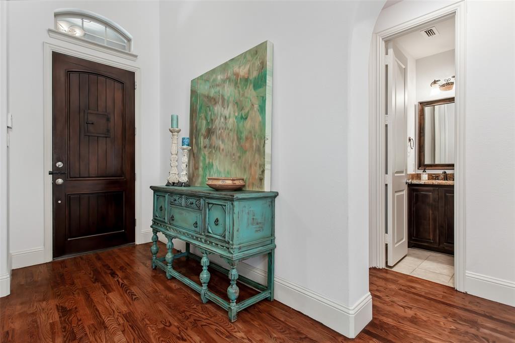 Arched entry with a wood door and transom window