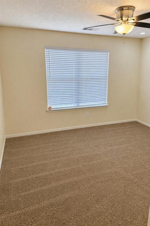 Carpeted room with a ceiling fan, recessed lighting, and window blinds