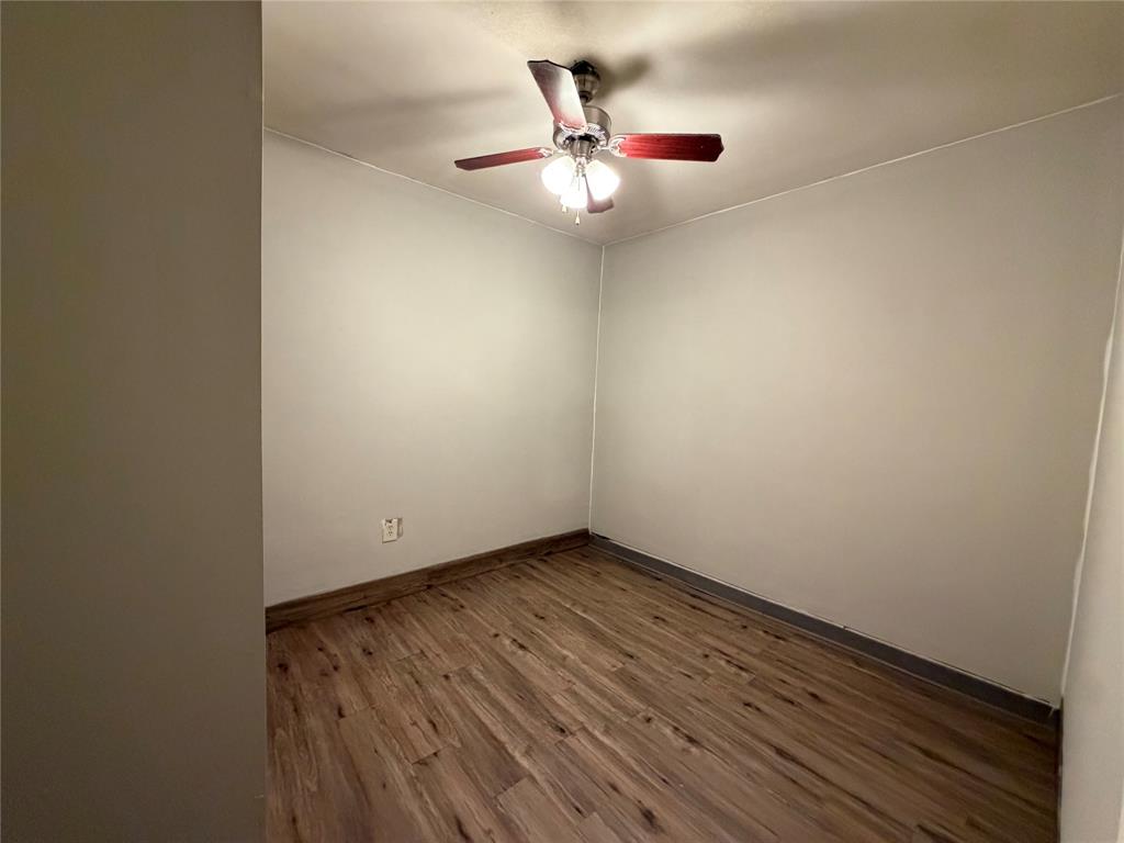 Wood-finish flooring with a ceiling fan light fixture