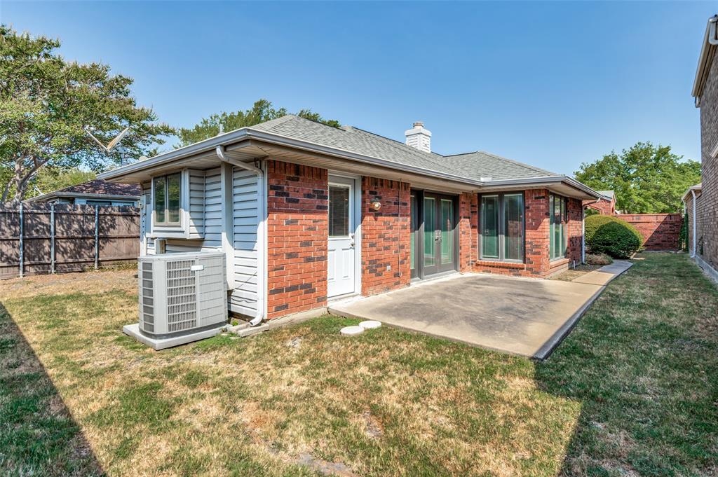 Brick exterior with siding accents, concrete patio, and mature landscaping