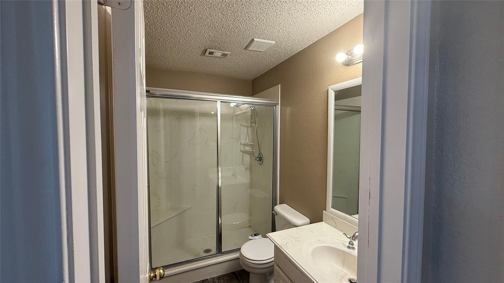 Bathroom featuring a shower with sliding glass doors, built-in shelving, and an integrated bench