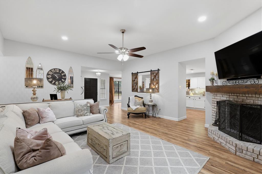 Brick fireplace with substantial wood mantel anchors the family room, with convenient access to the renovated kitchen.