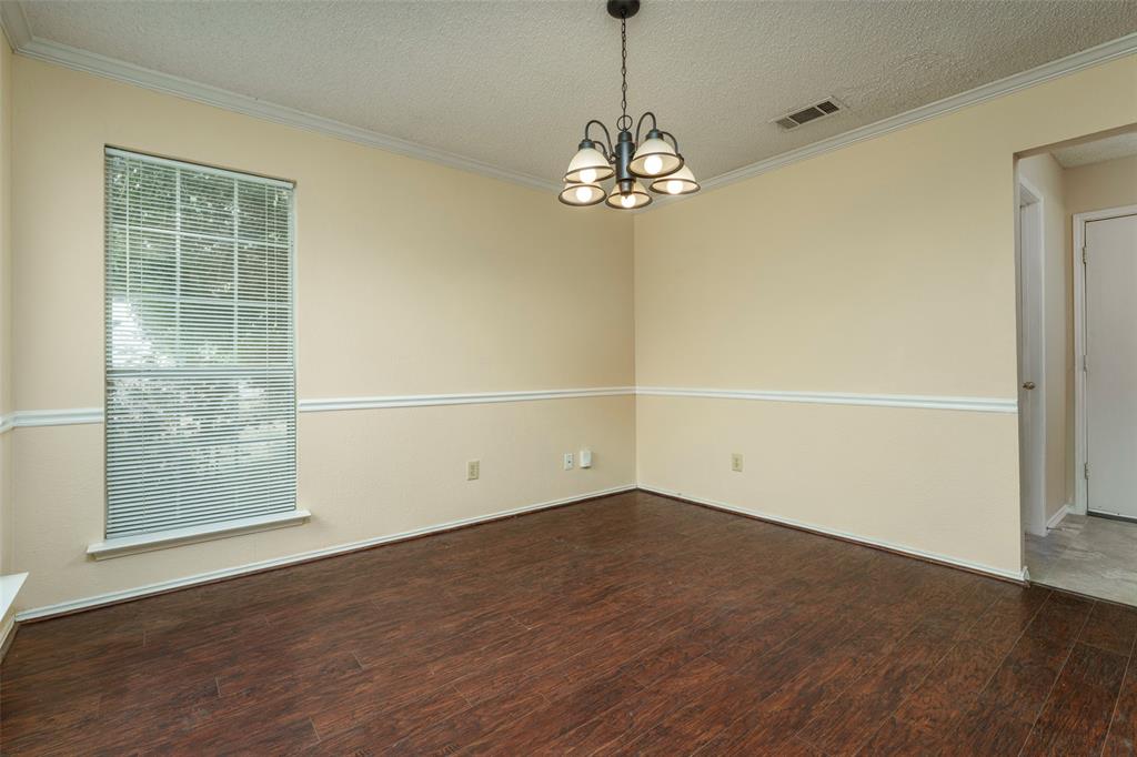 Dark wood-finish flooring with light wall paint and white trim molding
