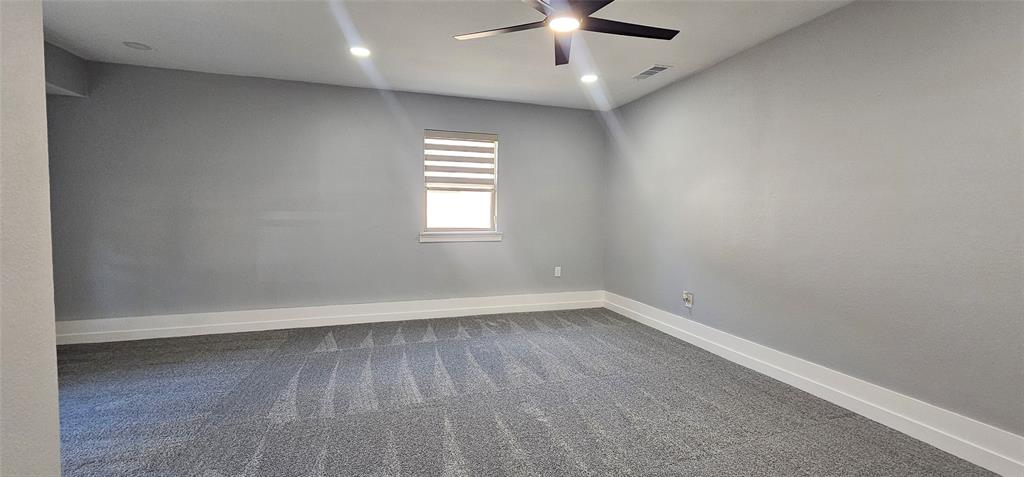 Recessed lighting, ceiling fan, window with horizontal blinds, gray walls, and gray carpeting