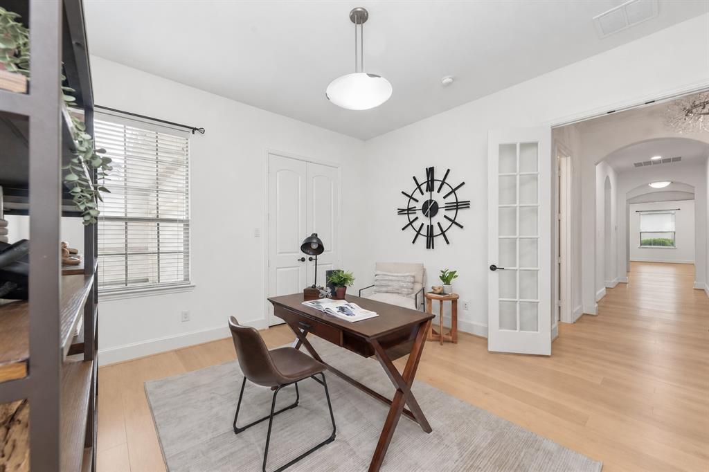 Recessed lighting, wood-finish flooring, white walls, double-pane window with blinds, and a white French door