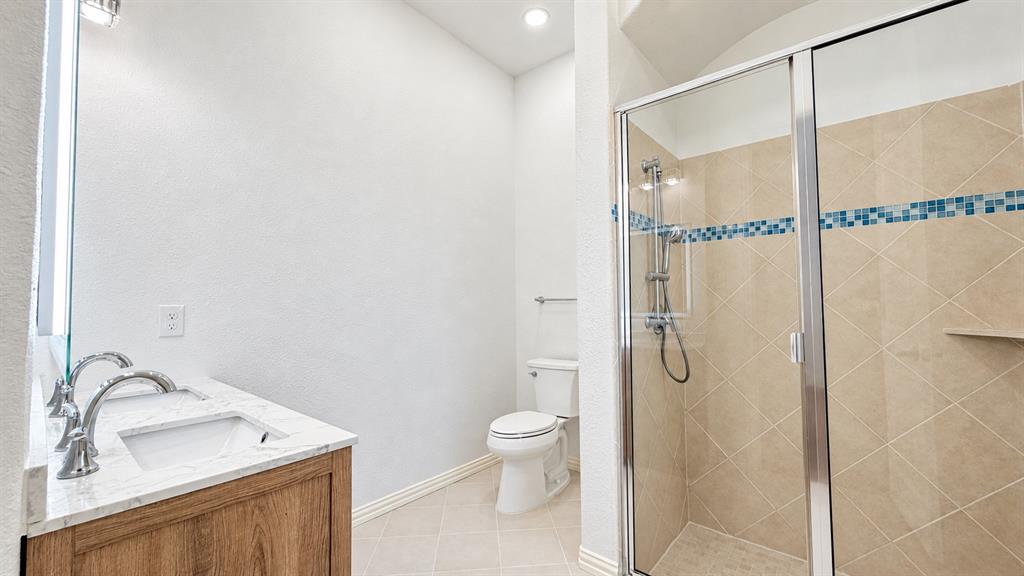 Dual vanity with wood-finish cabinetry and undermount sinks