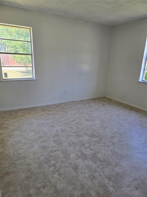 Neutral tone wall finish and textured ceiling