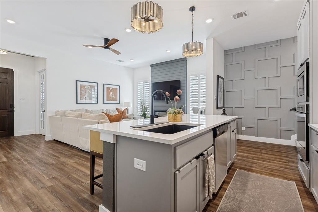 Gourmet kitchen island with an undermount sink and stainless steel appliances Gourmet kitchen island with an undermount sink and stainless steel appliances