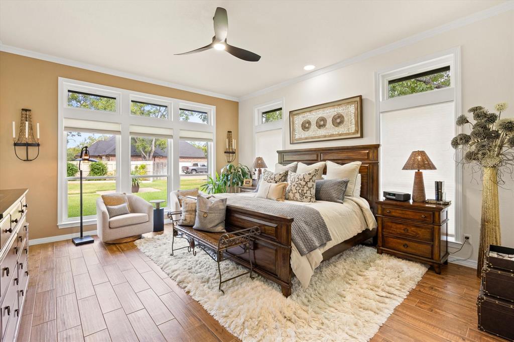 Large Primary Bedroom with Wall of Windows and Designer Accent Wall Paint, Overlooks Landscaped Backyard and Golf Course