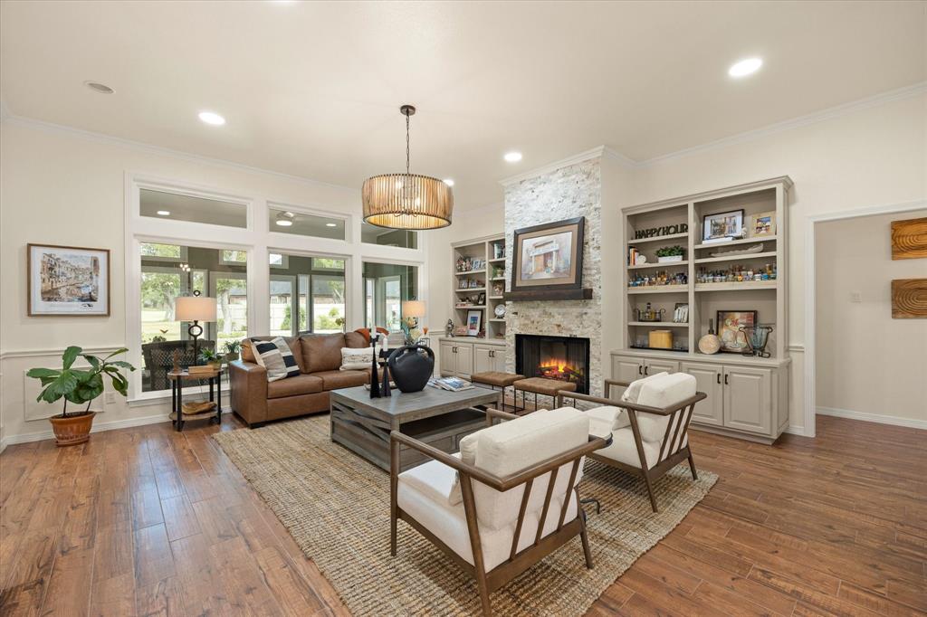 A Great Great Room! Gas Fireplace Featuring Stacked Stone, Custom-Built Cabinets and Bookcases. Designer Light Fixture Completes this space, A Great Great Room! Gas Fireplace Featuring Stacked Stone, Custom-Built Cabinets and Bookcases. Designer Light Fixture Completes this space,