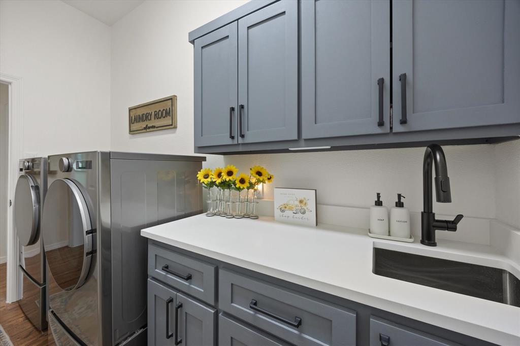Laundry Room Featuring Custom Upper and Lower Cabinets with Trash Drawer, New Quartz Countertops and Stainless-Steel Sink