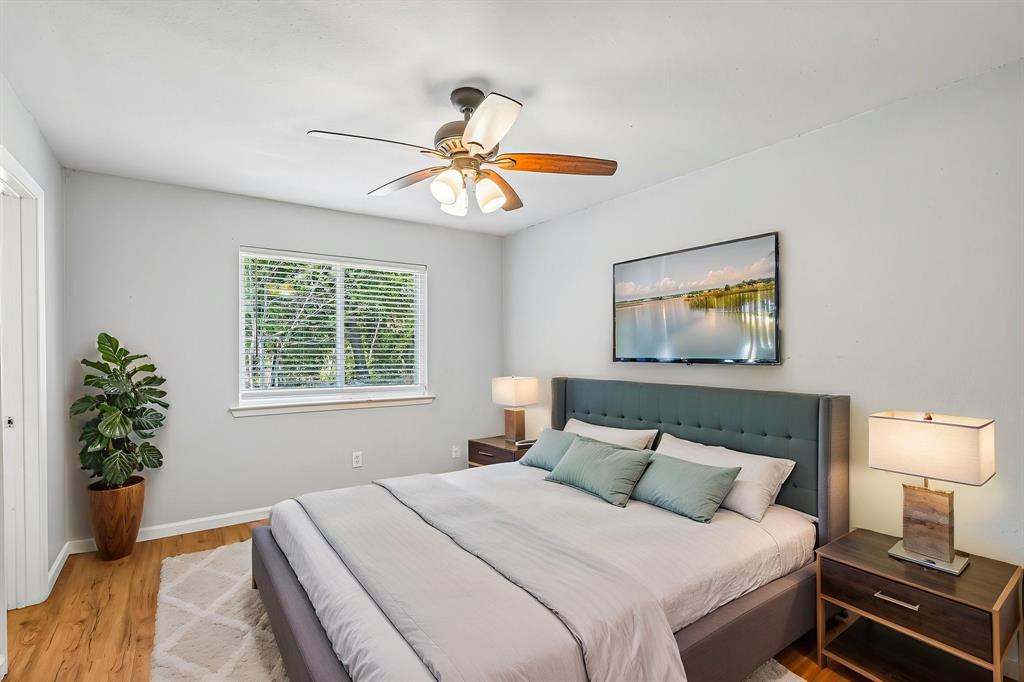 Wood-finish flooring, ceiling fan, and a window with blinds