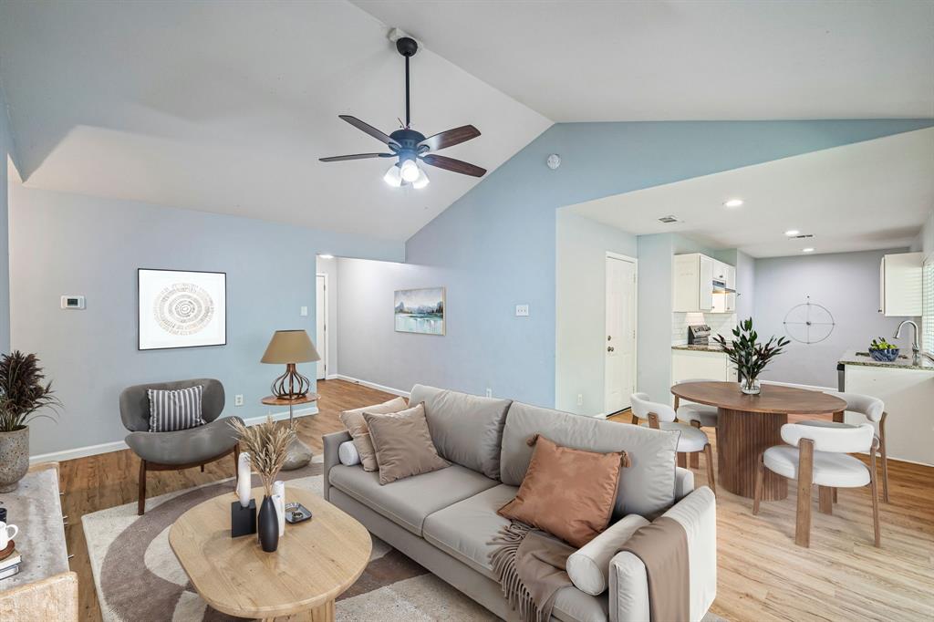 Vaulted ceilings, wood-finish flooring, ceiling fan, and recessed lighting