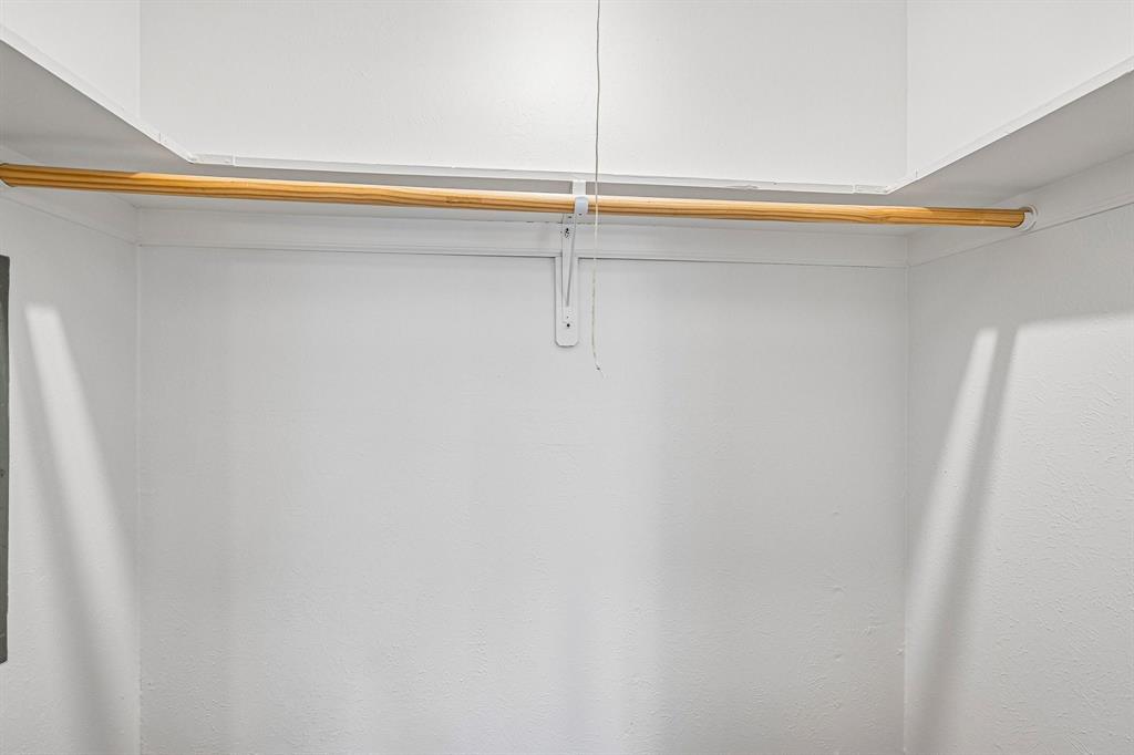 Recessed closet space with a built-in wooden hanging rod