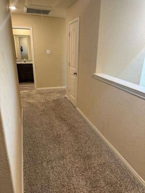 Textured carpeting throughout, featuring a built-in linen closet, and a half-wall architectural element