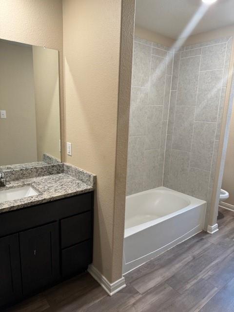 Bathroom featuring a built-in vanity with a granite countertop, undermount sink, and dark wood-finish cabinetry Bathroom featuring a built-in vanity with a granite countertop, undermount sink, and dark wood-finish cabinetry