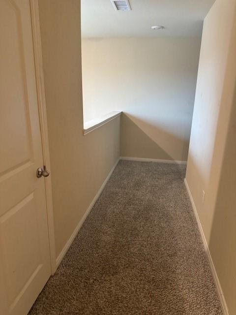 Neutral tone wall paint, textured carpeting, recessed ceiling lighting, and a white door with a round knob Neutral tone wall paint, textured carpeting, recessed ceiling lighting, and a white door with a round knob