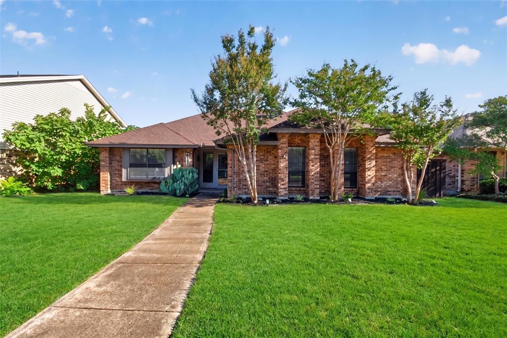 Brick exterior with a brown roof and mature landscaping Brick exterior with a brown roof and mature landscaping