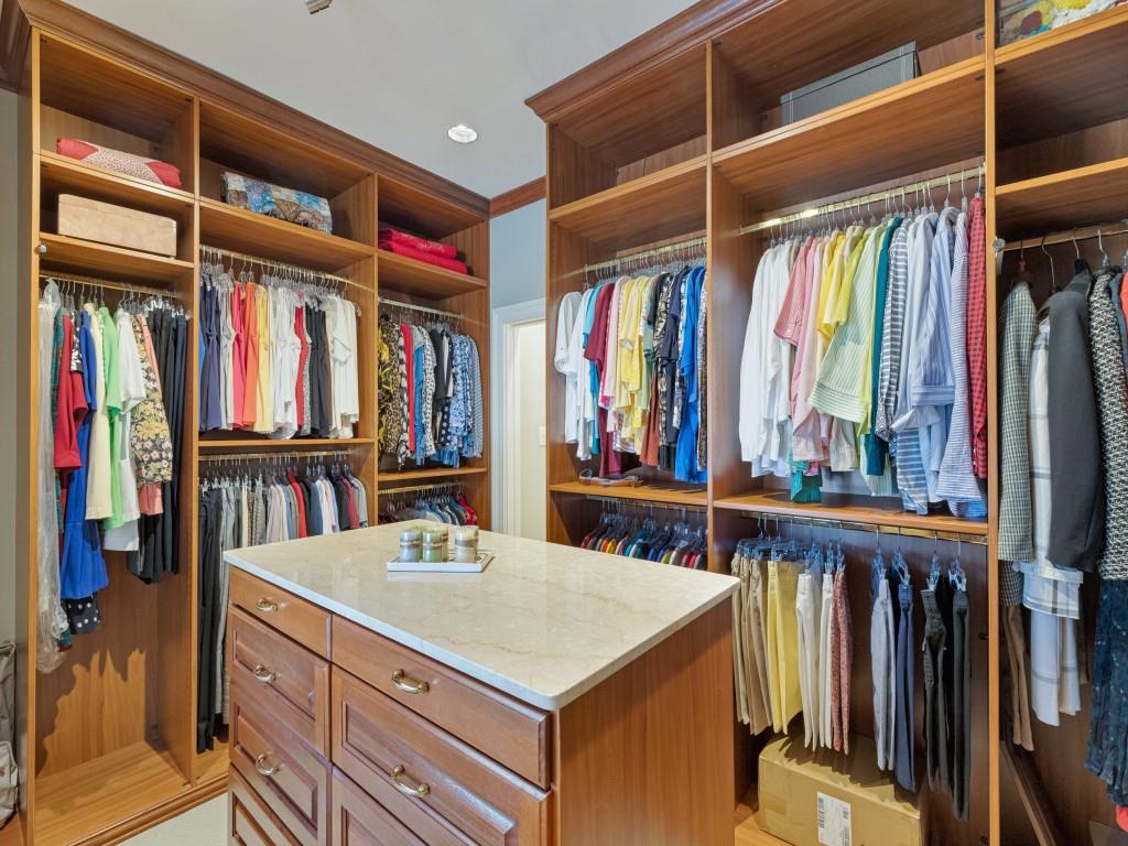 Custom closet system with wood-finish shelving and cabinetry
