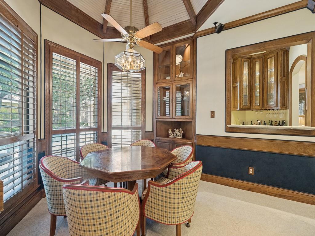 Octagonal room featuring wood-finish ceiling, built-in display cabinetry, and multiple windows with plantation shutters