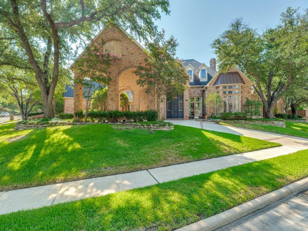 Brick exterior with a prominent arched entry and a turretted window feature