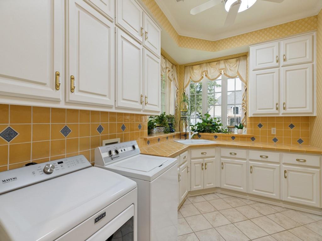 White cabinetry with gold-tone hardware, a tiled countertop, and a tiled backsplash with diamond accents