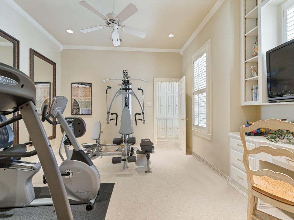 Recessed lighting, crown molding, ceiling fan, white plantation shutters, built-in shelving