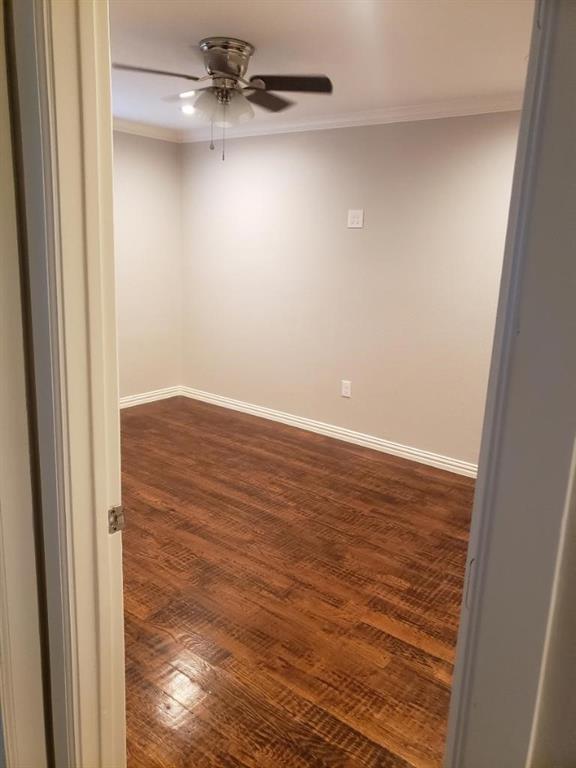 Wood-finish flooring, ceiling fan with light fixture, and crown molding