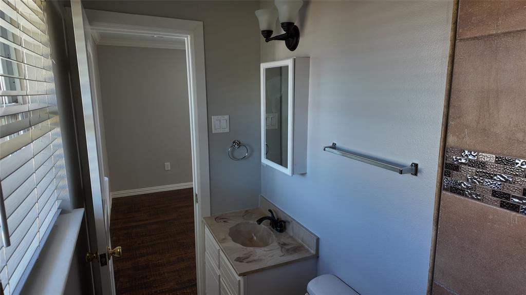 Vanity with integrated sink, wall-mounted light fixture, and medicine cabinet Vanity with integrated sink, wall-mounted light fixture, and medicine cabinet