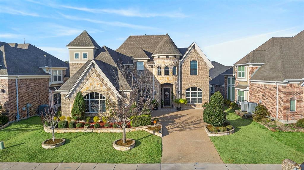 Brick and stone facade residence featuring multiple gables and turret architectural elements