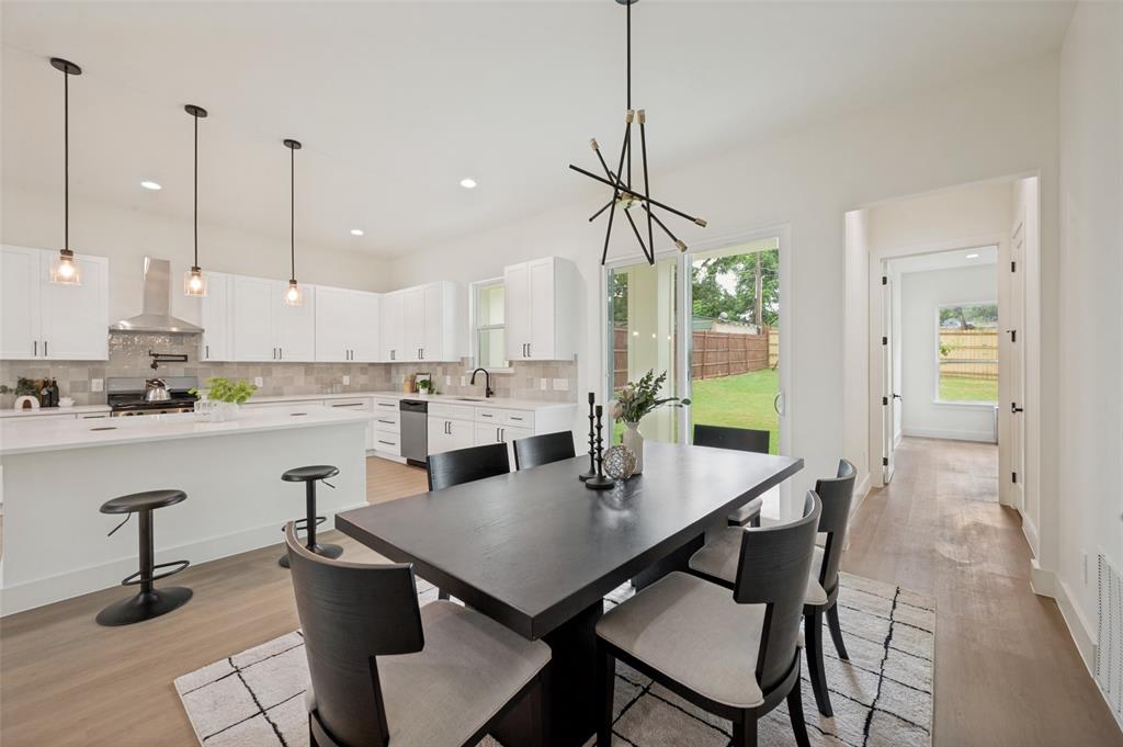 Modern kitchen with white cabinetry, stainless steel appliances, and a central island