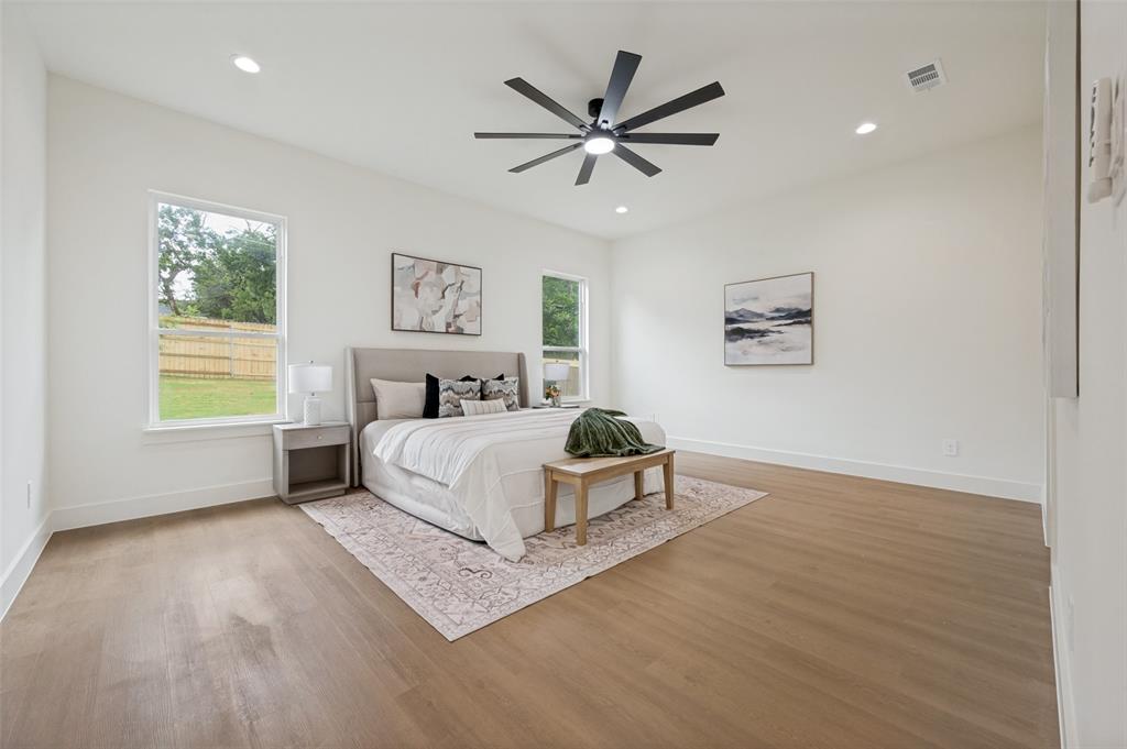 Spacious room featuring wood-finish flooring, recessed lighting, and a contemporary ceiling fan