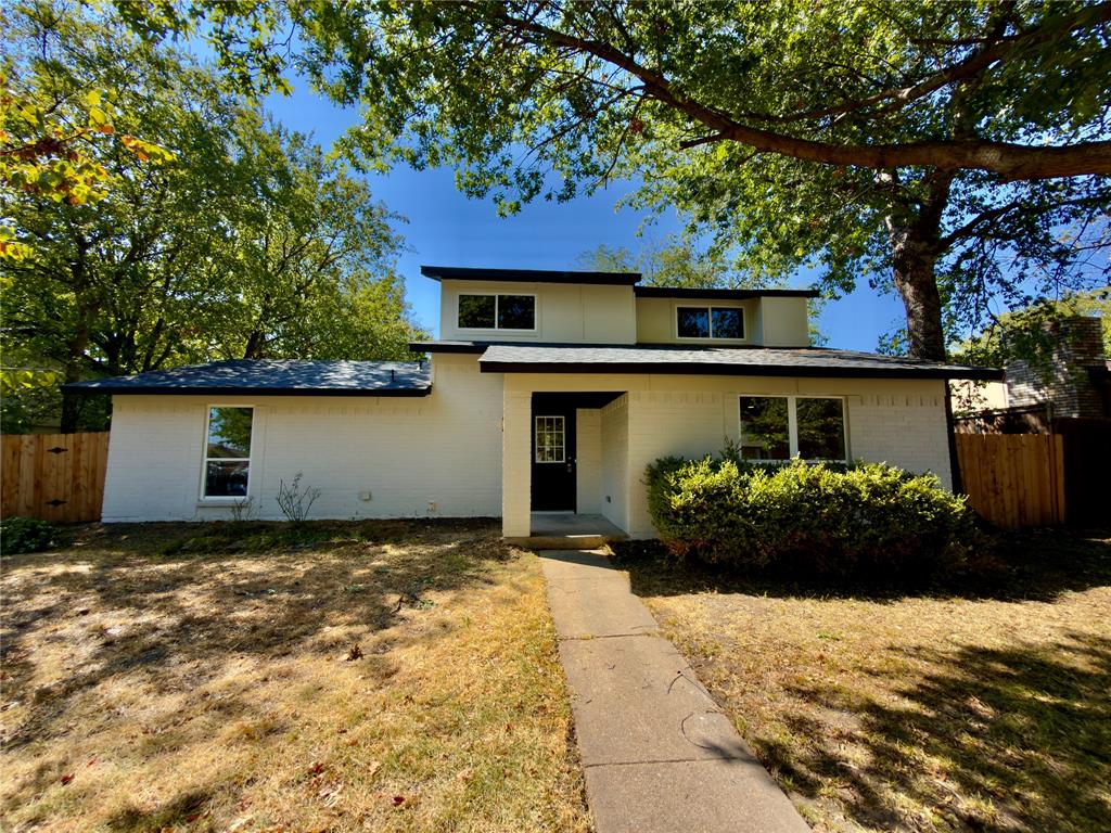 Contemporary architectural style with a white brick exterior and dark trim Contemporary architectural style with a white brick exterior and dark trim