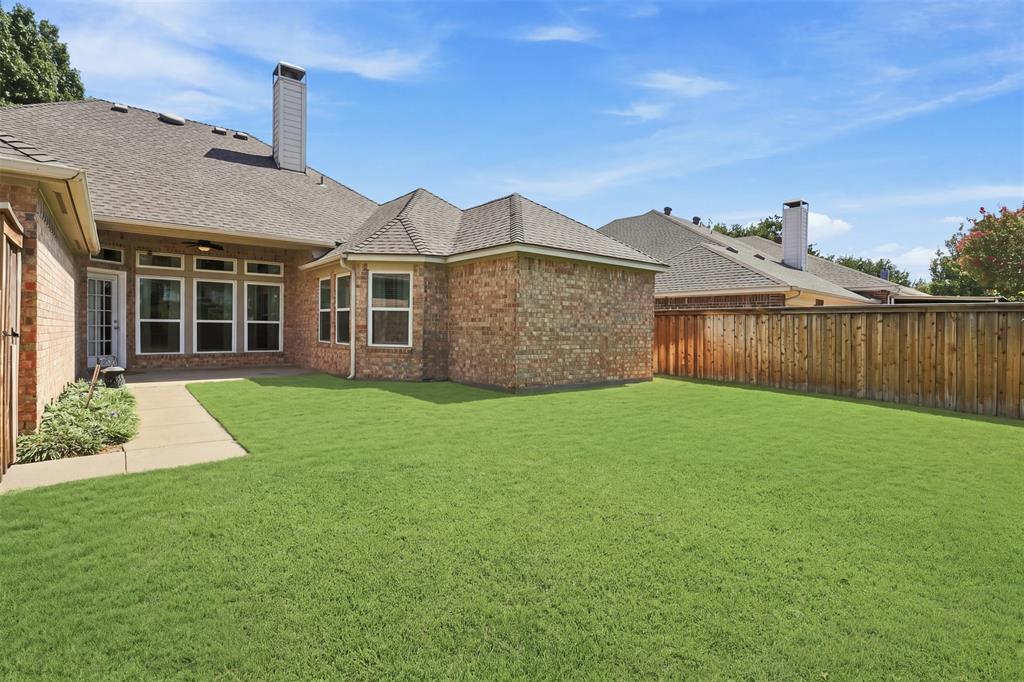 Large backyard with St Augustine grass and landscaping.