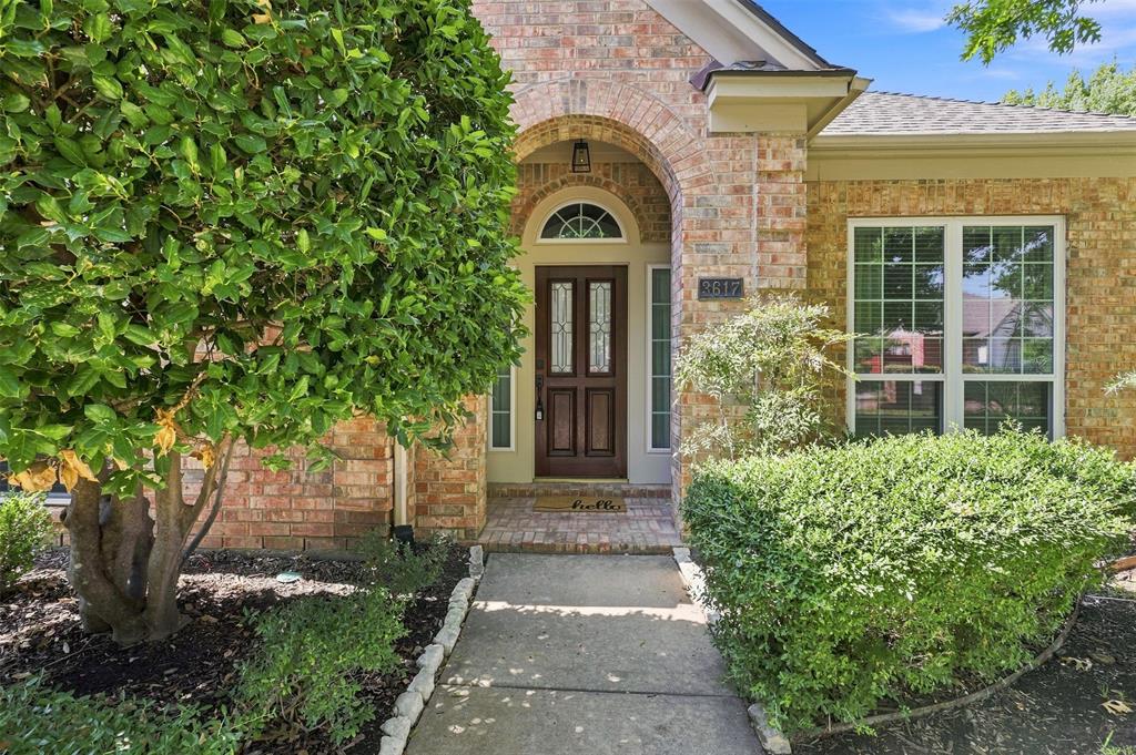 Welcome home to a covered front porch and upgraded wood door with glass inserts.
