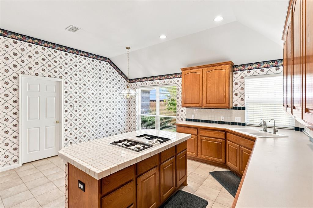 Island looks towards eat-in kitchen area for easy conversation during meal prep.