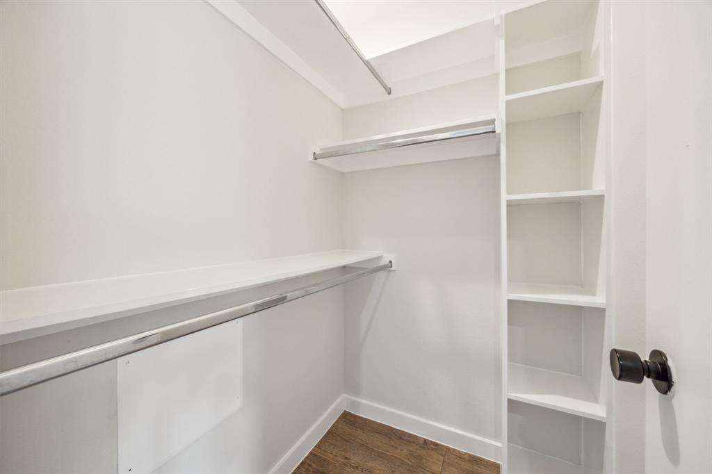 Integrated shelving, multiple hanging rods, and wood-finish flooring
