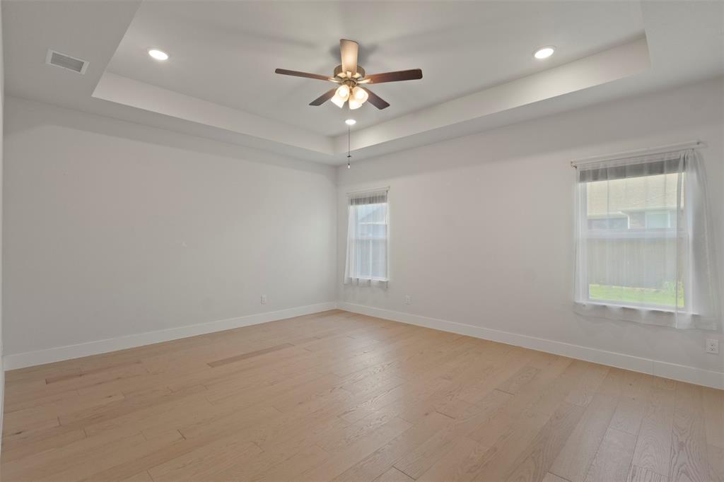 Primary Bedroom - tray ceiling and ceiling fan