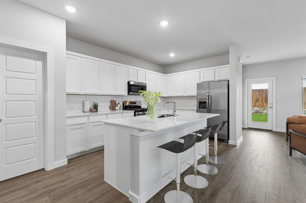 Kitchen in the Oscar home plan by Trophy Signature Homes – REPRESENTATIVE PHOTO Kitchen in the Oscar home plan by Trophy Signature Homes – REPRESENTATIVE PHOTO