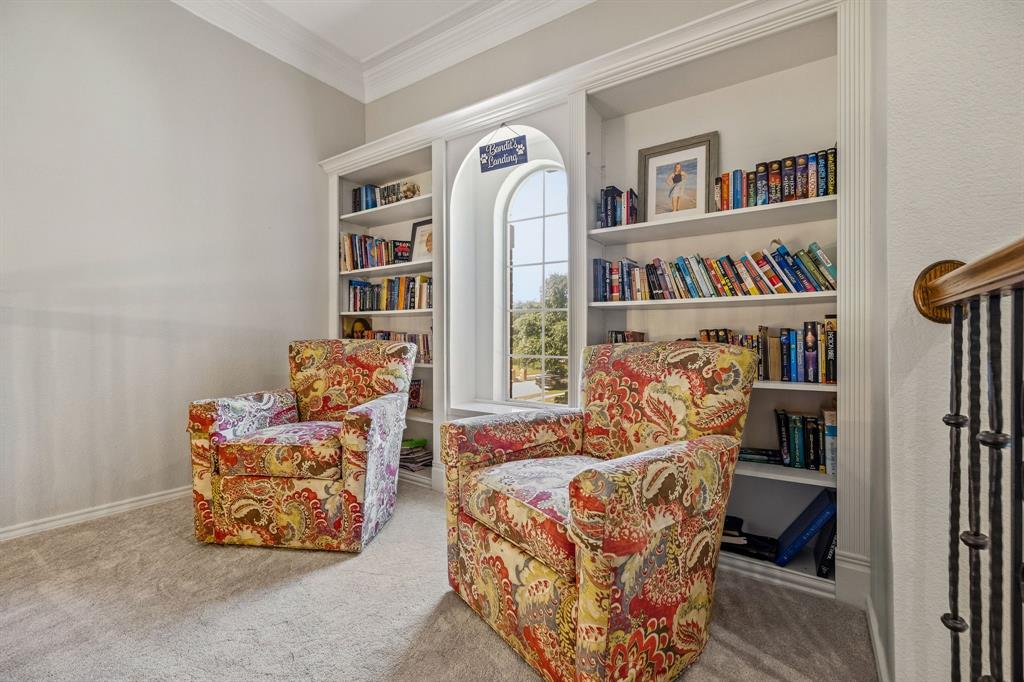 Upstairs library has built-in bookshelves & overlooks the entry.