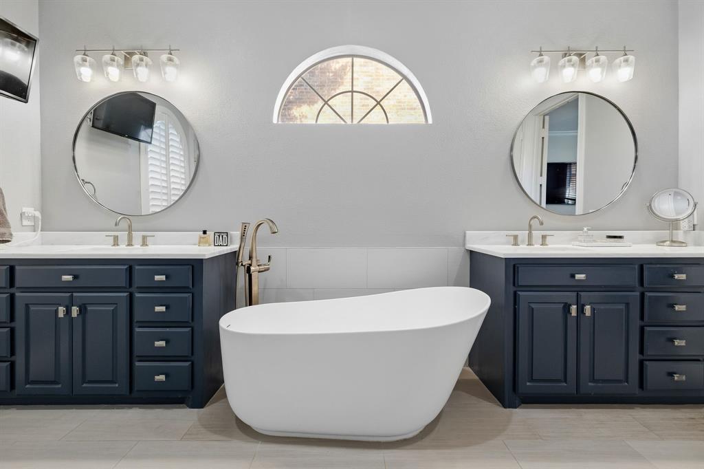 Magnificent bathroom remodel with free-standing tub & custom cabinetry with dual vanities.