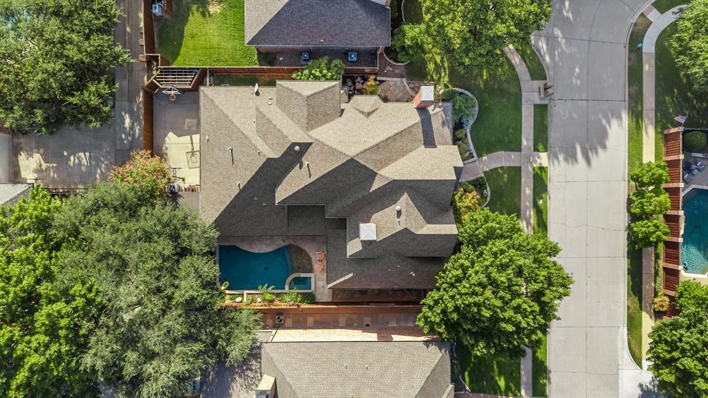 Sliding gate enclosing 3 car garage, 2 basketball goals, storage shed, dog run with laundry room access.